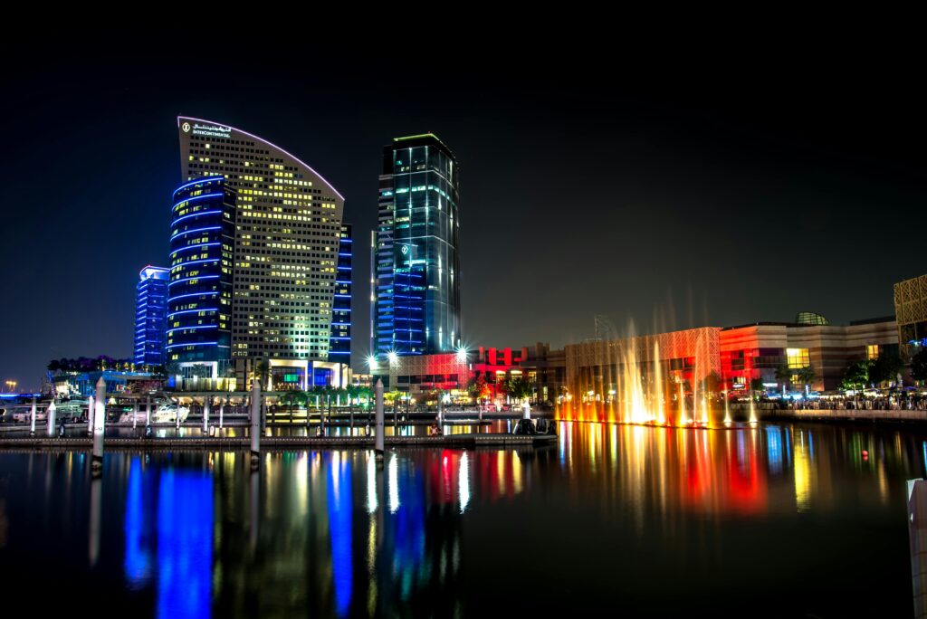 Stunning night view of Dubai's illuminated architecture reflecting on the water.